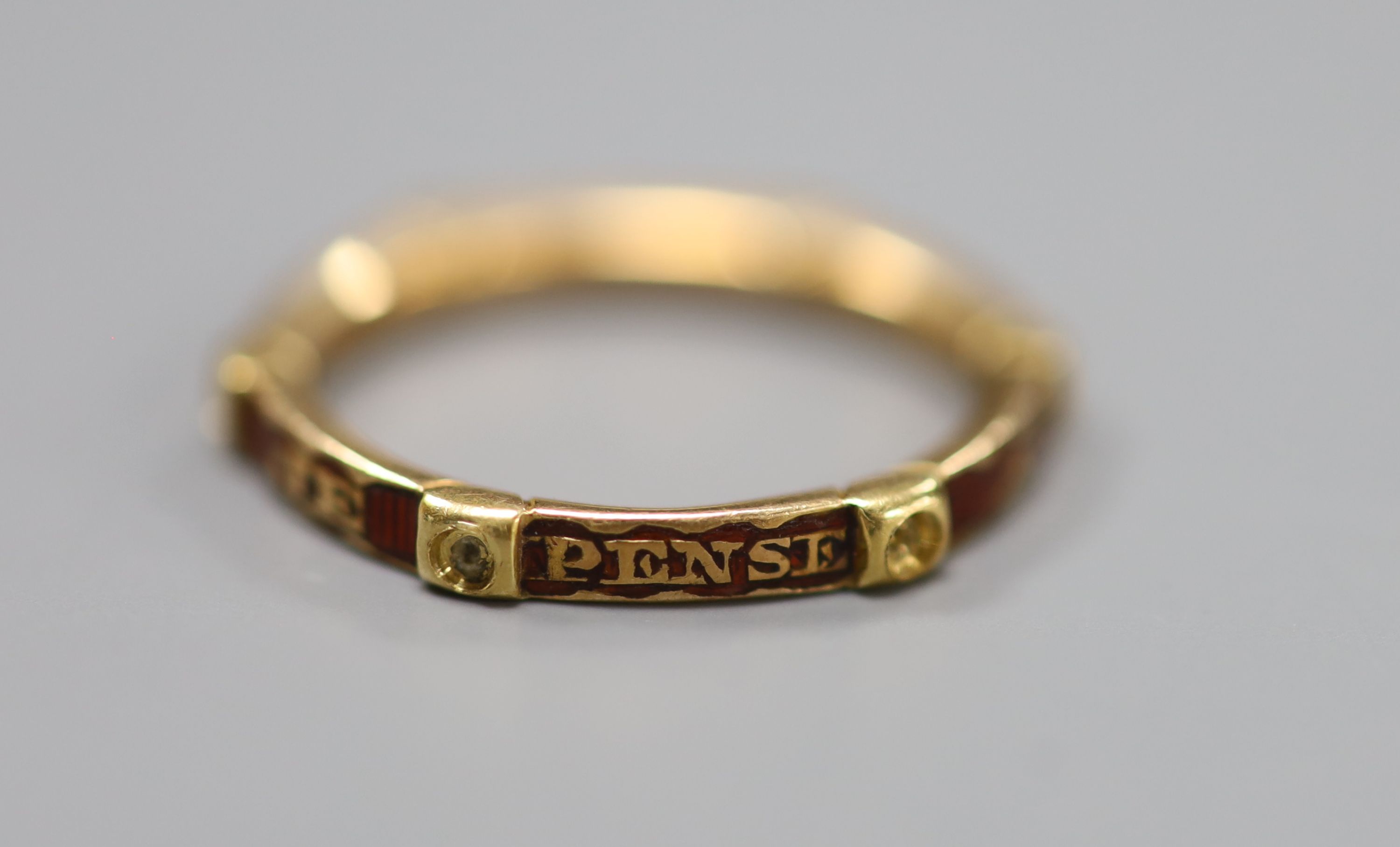 A French yellow metal and red enamel hexagonal band, inscribed Je Pense a Vous Tou Jours, (pearls? missing), size J,